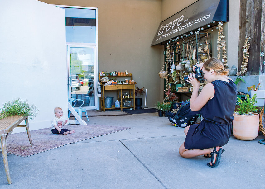 Marita Wantaja takes photos of a baby during her Mother's Day inspired photoshoots at the Trove gift shop in Battle Ground on Thursday, May 11.