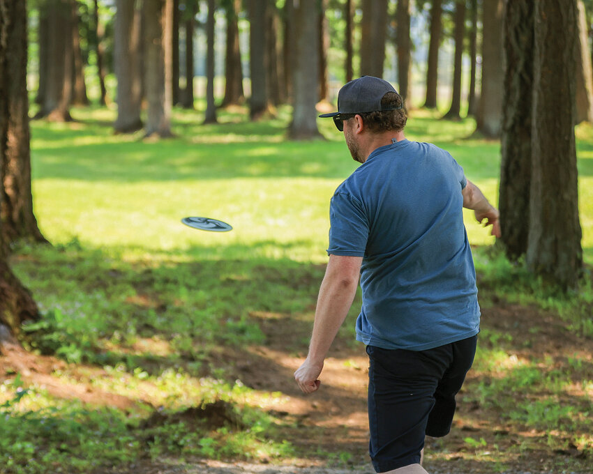 Clarke Pindar throws a disc during his first round at the new disc golf course at the Hockinson Meadows Community Park on Wednesday, May 24.