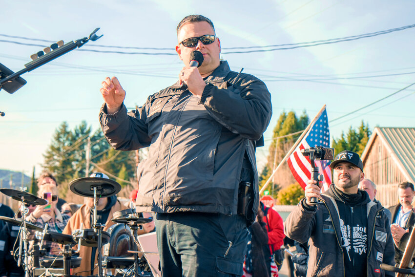 In this Chronicle file photo, Patriot Prayer Founder Joey Gibson films as Morton Police Chief Roger Morningstar speaks during a rally in downtown Mossyrock in December 2020.