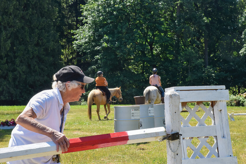 Fran Duncan adjusts an obstacle during the Clark County Saddle Club&rsquo;s trail course event on June 3.