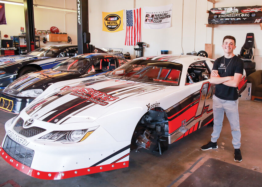 Eric Johnson Jr. stands with one of his three racecars in his shop in Woodland on Tuesday, May 30, prior to his NASCAR debut in Portland on Friday, June 2.