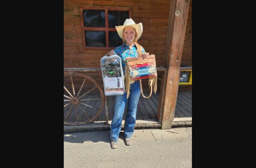 Sage Teitzel, of Onalaska, poses with prizes from a spring rodeo competition.