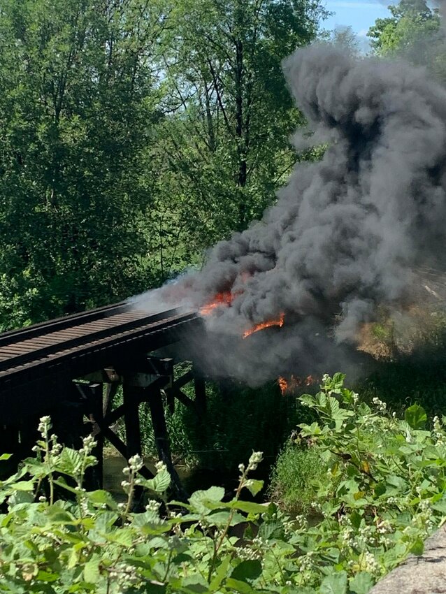 A fire burns on a Puget Sound &amp; Pacific Railroad trestle bridge south of Elma on June 3.