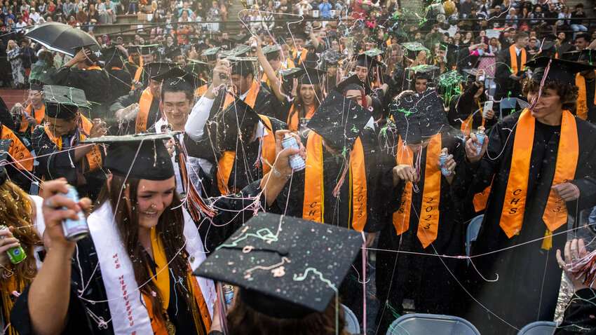 Centralia High School graduates cheer and spray Silly String after turning their tassels Friday night at Tiger Stadium.