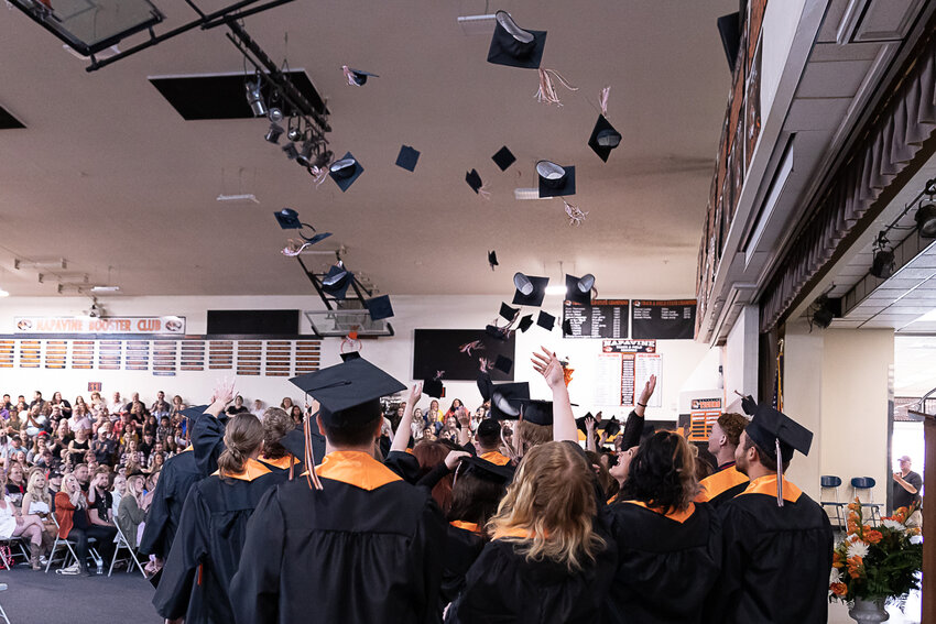 Napavine graduates throw their caps after the turning of the tassel at Napavine High School's graduation ceremony in the gym June 10.