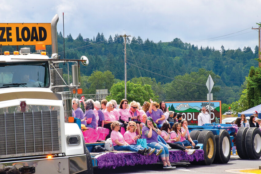 Past members of Woodland Planters Days royalty wave from the bed of a truck during the celebration&rsquo;s 100th-year parade on June 18, 2022.