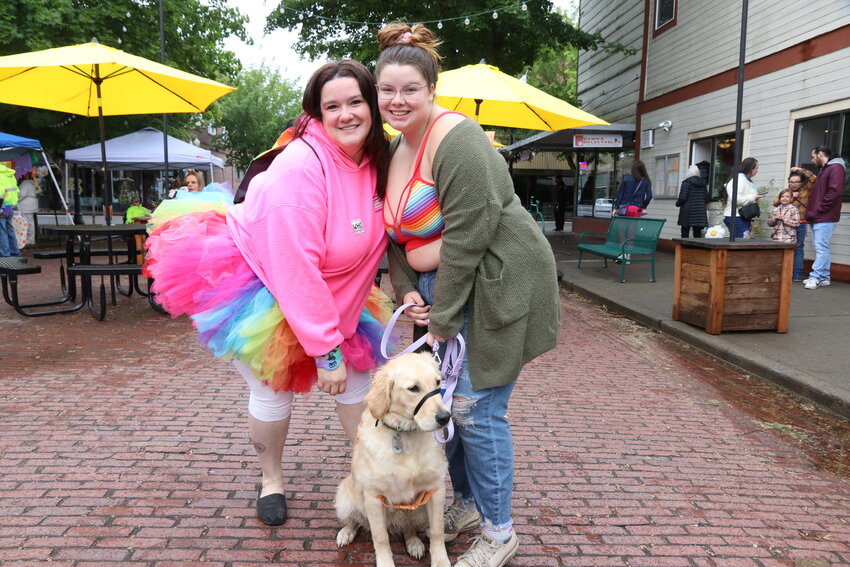 Trinity, Rachel and a dog named Laika pose for a photo at Lewis County Pride in Centralia on Saturday, June 10.