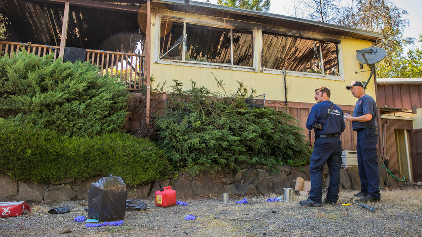 Fire investigators look at evidence of arson following a fire in Cinebar along East Zola Drive on Monday, June 12.