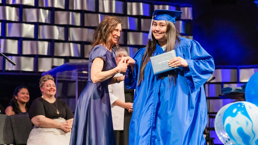 Futurus graduate Alejandra Robles smiles as she receives her diploma at the Centralia Community Church of God on Tuesday, June 13.