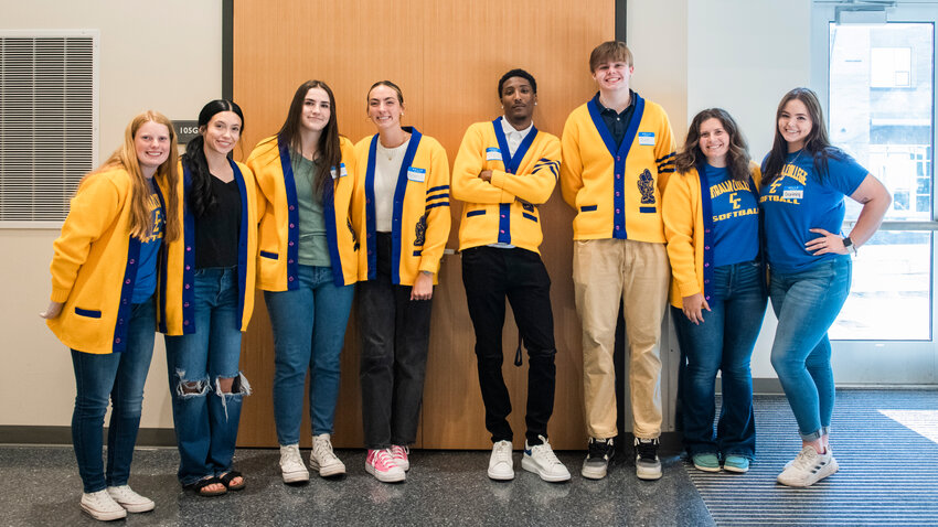 Athletes from left, Abbey Severse, Peyton Smith, Maggie Busse, Abigail Hansen, Tre Frazier, Ian Coates-White, Ava Bush and Courtney Backman pose for a photo while sporting cardigans and Centralia College attire during a Thursday evening ceremony called Centralia College Night of Celebration.