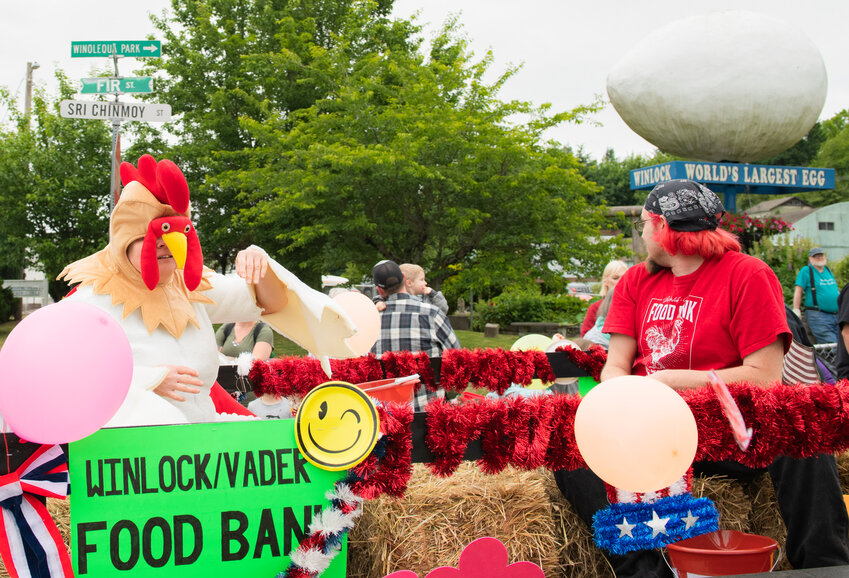 Volunteers from the Winlock/Vader food bank throw candy to paradegoers at the Winlock Egg Day parade in 2023.