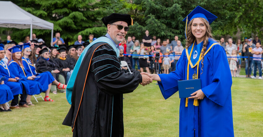 Centralia College graduate Kary Sathre smiles for a photo with President Bob Mohrbacher as she receives her diploma on Friday, June 16.