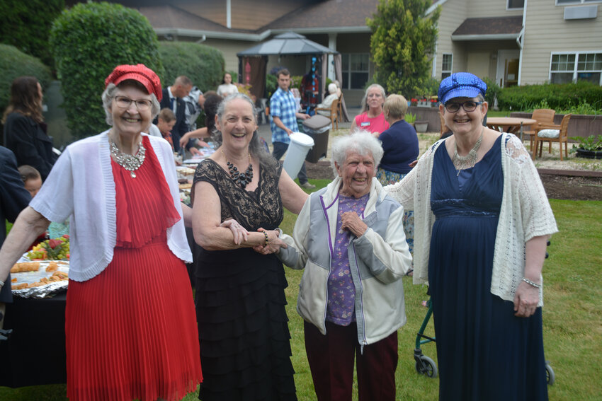 Attendees at Prestige Senior Living Rosemont&rsquo;s Prom smile for a photo on June 17.