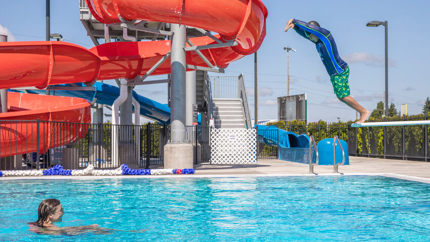 Participants in swim lessons at the Gail and Carolyn Shaw Aquatic Center leap off diving boards in Chehalis on Wednesday, June 21.