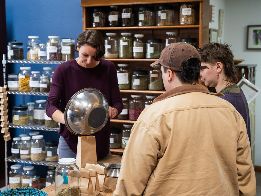 Stephanie Eschenwald prepares an herbal remedy for patrons following the ribbon-cutting at Nature Nurture Farmacy on Market Street in downtown Chehalis on Tuesday June 20, 2023.