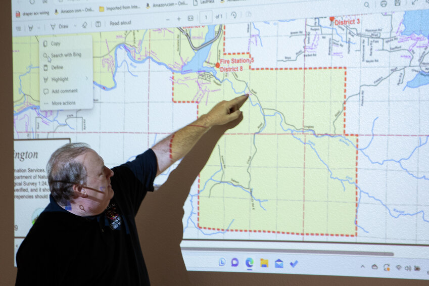 Lewis County Fire District 8 Chief Duran McDaniel points to a map of the fire district during a meeting Wednesday evening discussing a secondary evacuation route for residents in the Salmon Creek Road area.