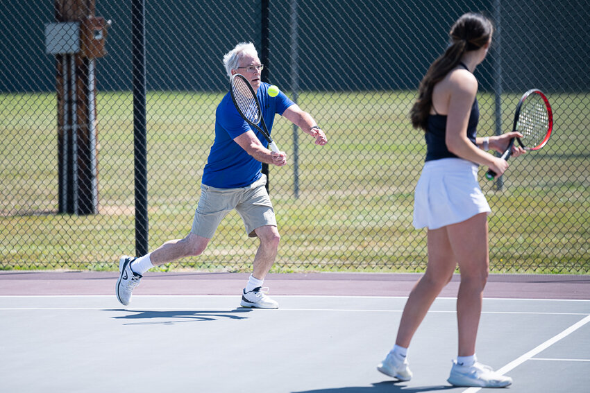 Rick Kuykendall charges in for a shot during a doubles game, paired with his daughter Claire, at the Jack State Alumni tournament, June 24 in Chehalis.