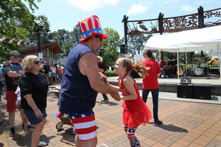 Kaydence Senter Nelson dances with her grandfather Tony Benson at the 4th of July celebration in Ridgefield in 2019