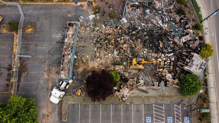 Photos by Jared Wenzelburger / jared@chronline.com  Sandrini Construction crews work Wednesday morning to fill LeMay shipping containers with debris from the former Papa Pete&rsquo;s Pizza and Shari&rsquo;s Restaurant location in Centralia after a fire destroyed the building on Harrison Avenue in early March. Christopher Jackson Jr. was convicted for breaking into the building on Sunday, March 5, lighting a Sterno can on fire and then accidentally knocking it over, spilling the flaming fluid and starting the fire that destroyed the building. He was sentenced last week to three to six months in a court-imposed residential drug offender sentencing alternative inpatient program.  The hexagon-shaped building where Papa Pete&rsquo;s was most recently located originally opened in January 1983 as the 26th restaurant in the Shari&rsquo;s chain, according to previous Chronicle reporting. Shari&rsquo;s closed in 2007, but the building remained.  Three years later, in June 2010, the Castle Rock-based chain Papa Pete&rsquo;s Pizza announced it would open a new location in the hexagon-shaped building on Harrison Avenue.  At 4,300 square feet, the Centralia location was Papa Pete&rsquo;s smallest eatery, according to previous Chronicle reporting. The pizza chain operated on Harrison Avenue through February 2022 before permanently closing its Centralia location. According to Lewis County Parcels, the property is owned by Vahan Dinihanian of 933 Harrison Avenue Centralia LLC. About $16,500 is owed in taxes on the property.