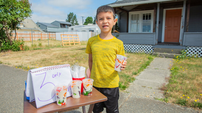 Zeuirel Nava, 8, sells jello cups for three dollars each in the 1000 block of West Main Street in Centralia on Wednesday, June 28.