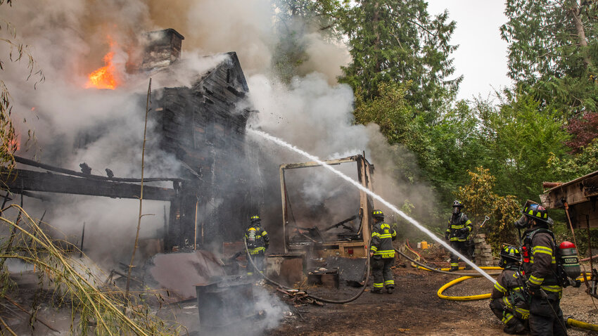 Riverside Fire Authority, Centralia police and Chehalis firefighters respond to the scene of a structure fire in the 1100 block of Eckerson Road in Centralia on Friday, June 30.