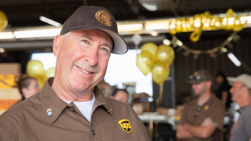 Mike Cain smiles while talking about his years of service as a UPS driver in the Rochester area during a celebration in his honor at the UPS Customer Center in Chehalis on Thursday, June 29.