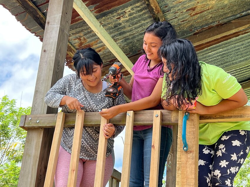 Estafani (center) and other girls from Worldwide Heart 2 Heart Children's Village join Bethel Church mission team members to install new railings as part of work to repair infrastructure at the foster home in Honduras. Bethel has sent annual groups to the village for a decade. Sixteen Bethel members went on this year's trip.