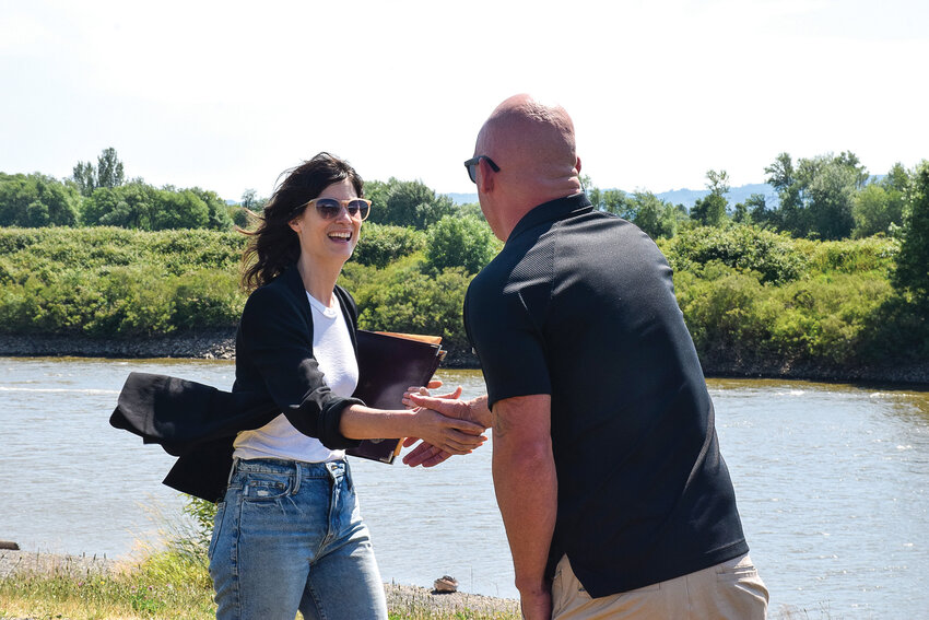 U.S. Rep. Marie Gluesenkamp Perez, D-Skamania County, greets Port of Ridgefield CEO Randy Mueller as she arrives for an outdoor port meeting at the Ridgefield waterfront on June 26.