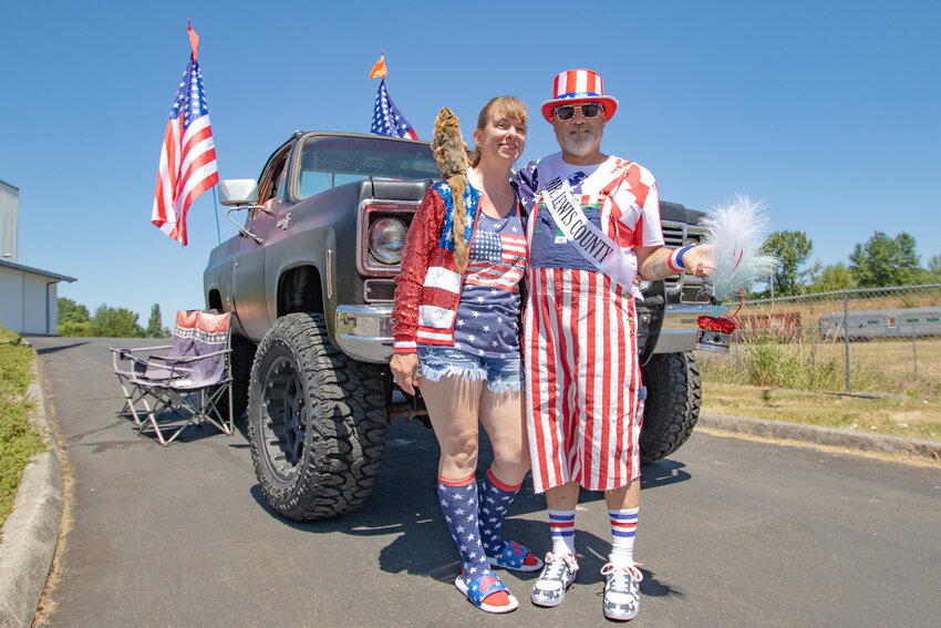 Mr. Lewis County winner Tom Craswell poses with his girlfriend, Holly Stender, after winning the his title, along with a squirrel beer koozie he was awarded and a trophy he won during the Cruise &amp; Coffee Car Show in front of his 1978 Chevrolet pickup truck at the Veterans Memorial Museum on Saturday.