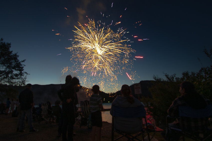 Fireworks explode over Mineral Lake from the Mineral Lake Lions Den Campground Saturday evening during the community&rsquo;s Freedom and Fishing event organized by the Mineral Lake Lions Club.