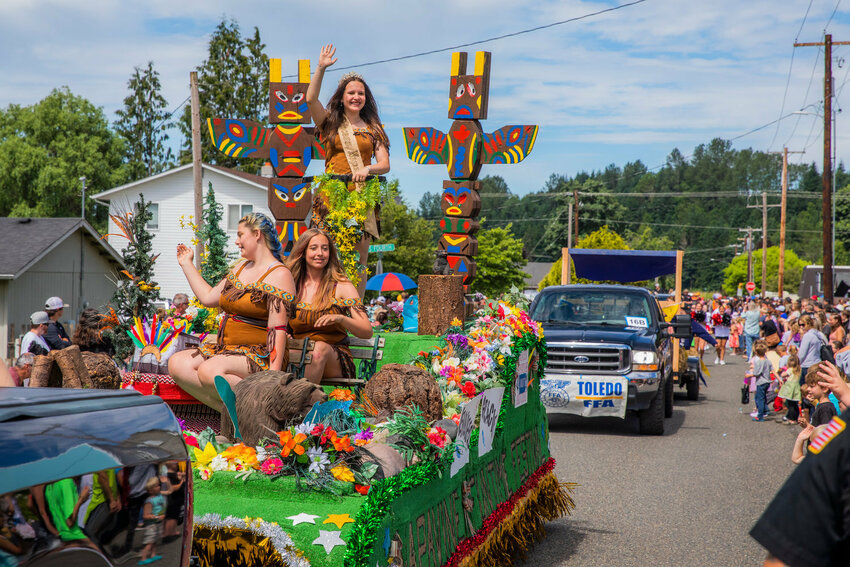 Three girls dressed as the Napavine Funtime Festival mascot Princess Napawinah wave to the crowd during the Toledo Cheese Days parade in July 2022.