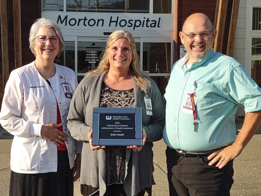 Morton Hospital CEO Robert Mach, right, Quality Manager Julie Johnson, center, and Chief Nursing and Quality Officer Sara Williamson, left, pose with the 2023 Critical Access Hospital Achievement of Quality Excellence award from the Washington State Hospital Association in this courtesy photo.