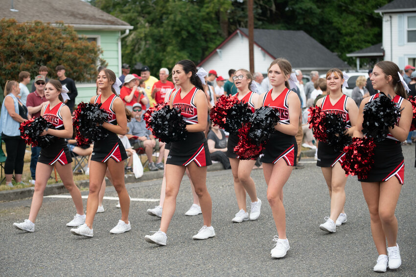 The Toledo High School cheer team walks down Augustus Street at the Toledo Cheese Day Parade on July 8, 2023.