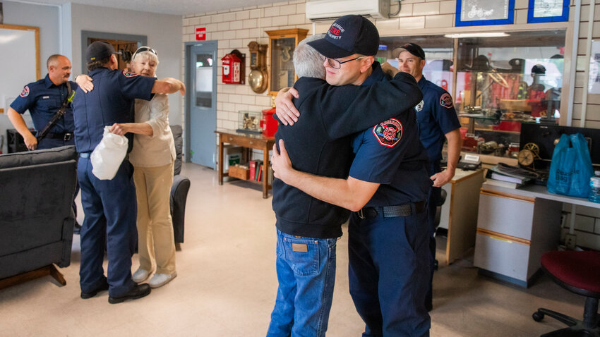 Darren Banks, the lead medic on an April call to save the life of Scott Olson, 67, hugs Olson after describing how a defibrillator was used 11 times before Olson&rsquo;s heart was stabilized. The reunion occurred Wednesday morning at the Riverside Fire Station along North Pearl Street in Centralia.