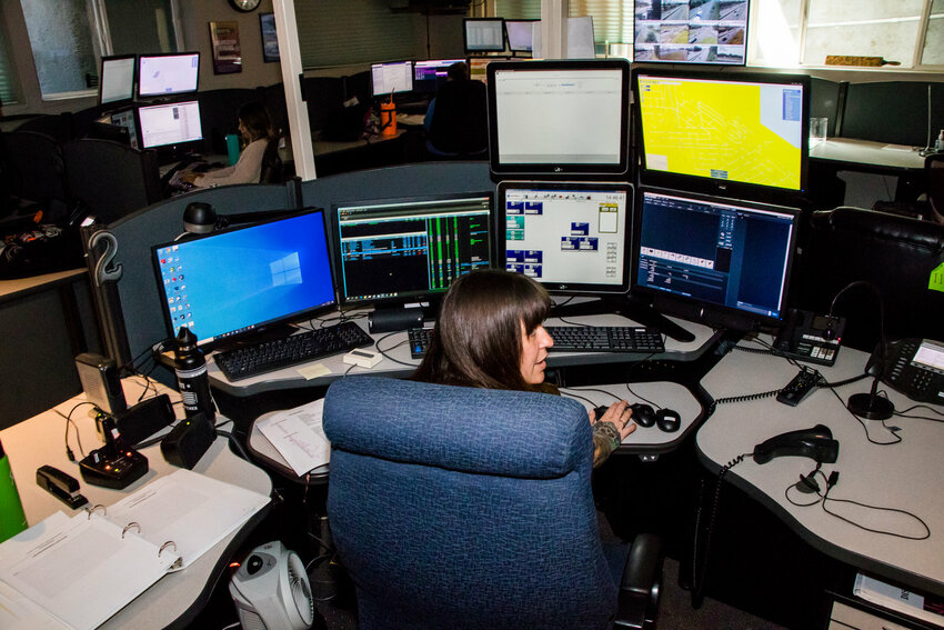 A dispatcher uses one of three mouses to control her computer screens at the 911 Dispatch Center in August 2019.