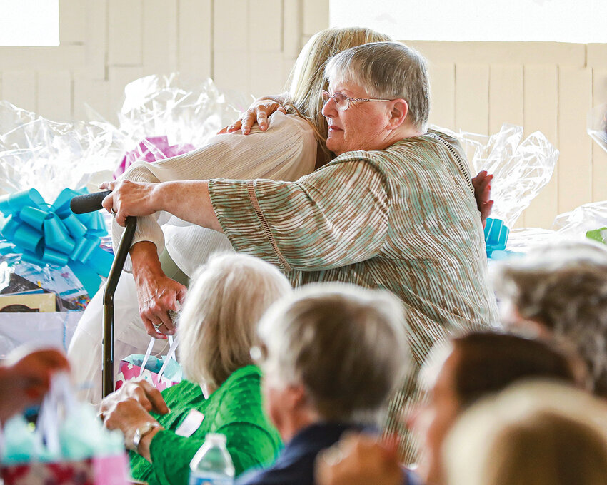 Sharon Wodtke, right, president of Battle Ground Seniors Citizens, hugs Debi Friesz during the seventh annual Senior Heroes Awards ceremony at the Pearson Air Museum in Vancouver on Wednesday, July 12.