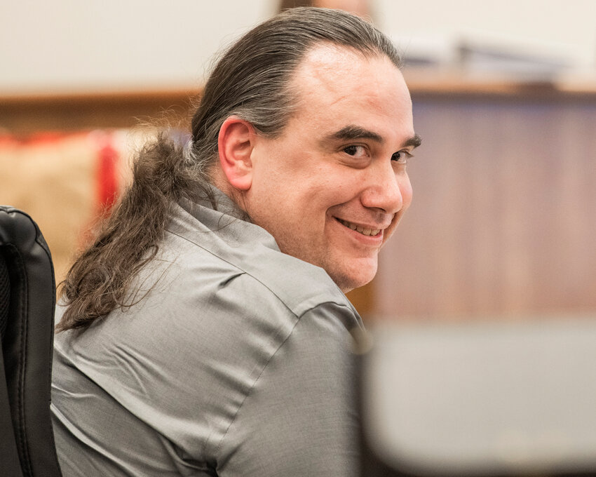 Two Dogs Salvatore Fasaga looks back at the camera and smiles during an appearance in Lewis County Superior Court in Chehalis last June.
