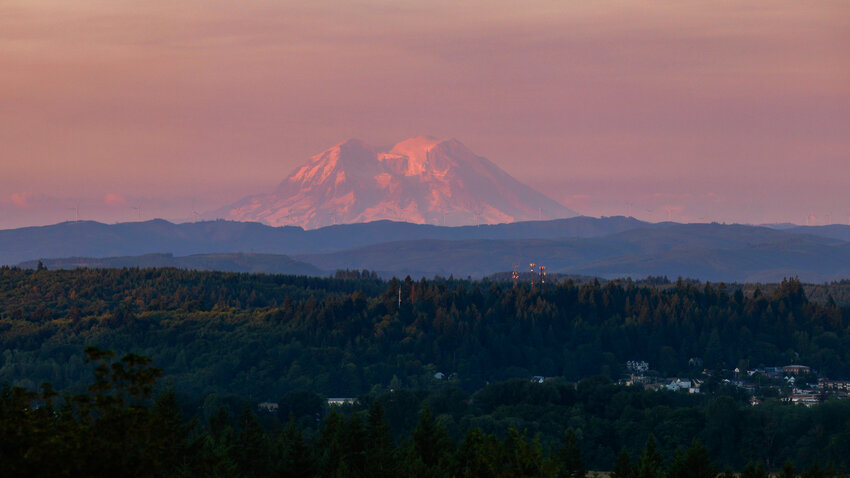 The summit of Mount Rainier is seen illuminated at sunset from West of Chehalis on Wednesday.