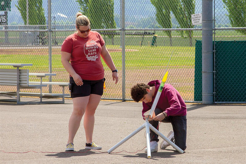 Woodland High School teacher Jennifer Benedict is pictured with a student prepping a rocket.