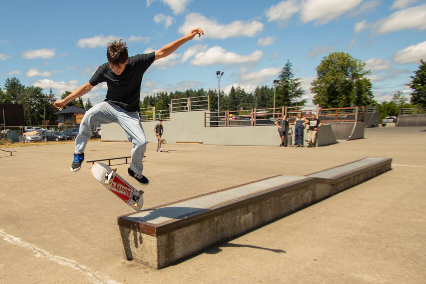 Lafel Denetclaw does a kickflip off a hubba at Fullers Twin City Skate Park during the intermediate best trick competition on Saturday, July 22.