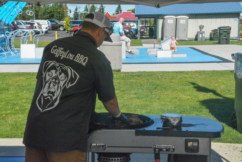A member of GriffeyLou BBQ prepares smoked chicken for the Amateur Andy&rsquo;s Competition at the Nisqually Valley Barbecue Rally on July 22.