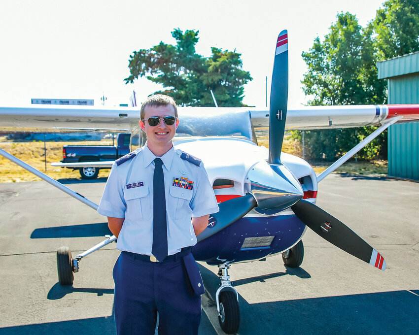 Second Lt. Jadon Santarpio, of La Center, stands with a Civil Air Patrol Cessna 182 aircraft on Wednesday, July 26, at Pearson Field in Vancouver.