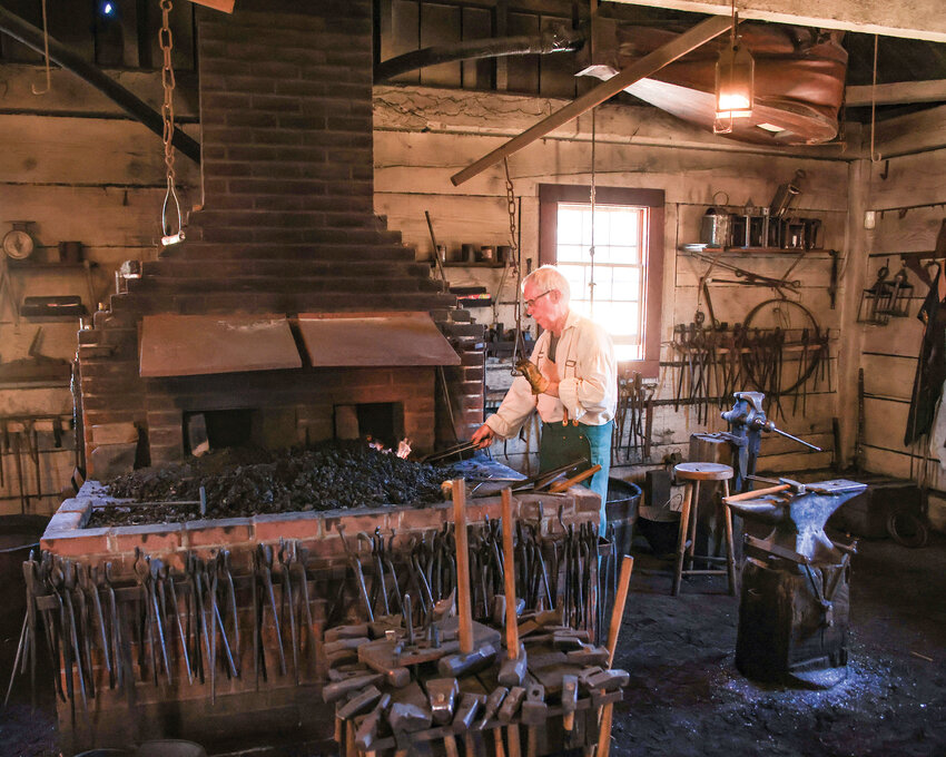 A blacksmith is hard at work in the blacksmith shop at the Fort Vancouver National Historic Site on Saturday, July 22.