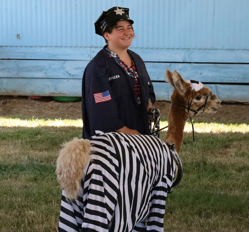 Isabella Pieri and her alpaca Midas dress as an officer and inmate for the Llama and Alpaca Costume Contest at the Clark County Fair Aug. 3, 2019.