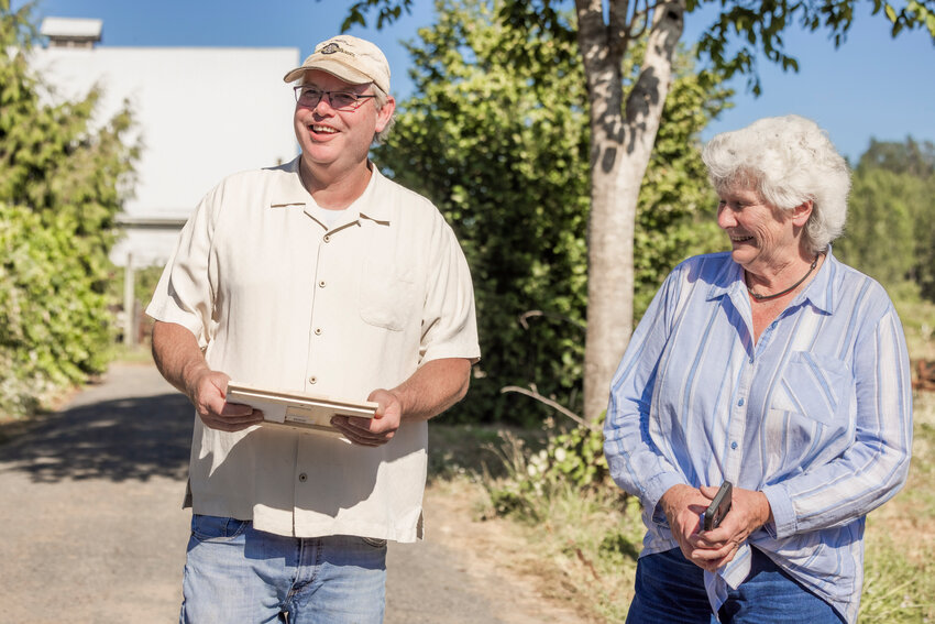 Dan Maughn smiles while talking about beekeeping after receiving a gift from Lewis County Farm Bureau President Maureen Harkcom, the author of this commentary, during a tour on Monday, July 31.
