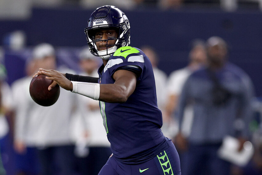 Seattle Seahawks quarterback Geno Smith looks for an open receiver against the Dallas Cowboys in the first quarter a preseason game at AT&amp;T Stadium on Aug. 26, 2022, in Arlington, Texas. (Tom Pennington/Getty Images/TNS)