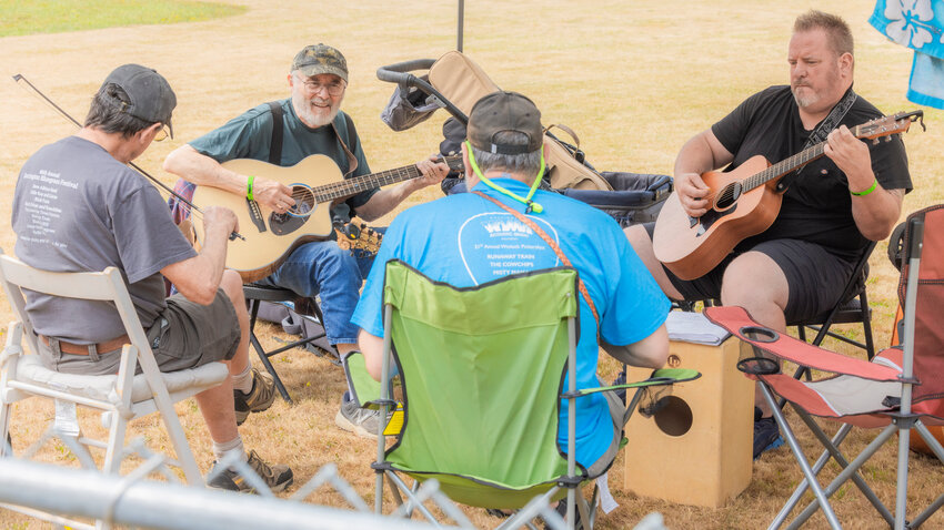 From left, Reade Obern, Gary Burns, John Batholomew and Mike Brown play instruments at Winolequa Park during Pickersfest in Winlock on Sunday, Aug. 6.