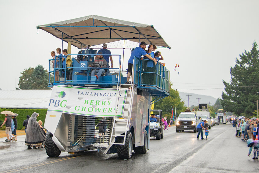 Panamerican Berry Growers members toss candy to parade attendees atop a berry harvester on Saturday, Aug. 5, during the Mossyrock Blueberry Festival parade.