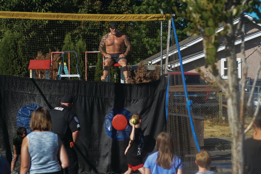 A youth at Yelm&rsquo;s National Night Out on Aug. 1 attempts to submerge Police Chief Rob Carlson in a dunk tank.