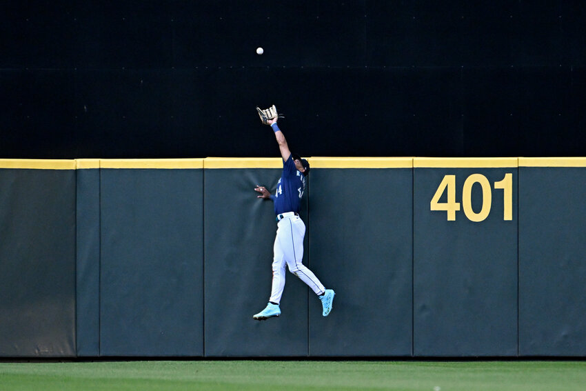 Seattle Mariners center fielder Julio Rodriguez makes a fourth-inning catch at the wall to retire the San Diego Padres' Fernando Tatis Jr., not pictured, at T-Mobile Park on Tuesday, Aug. 8, 2023, in Seattle. (Alika Jenner/Getty Images/TNS)